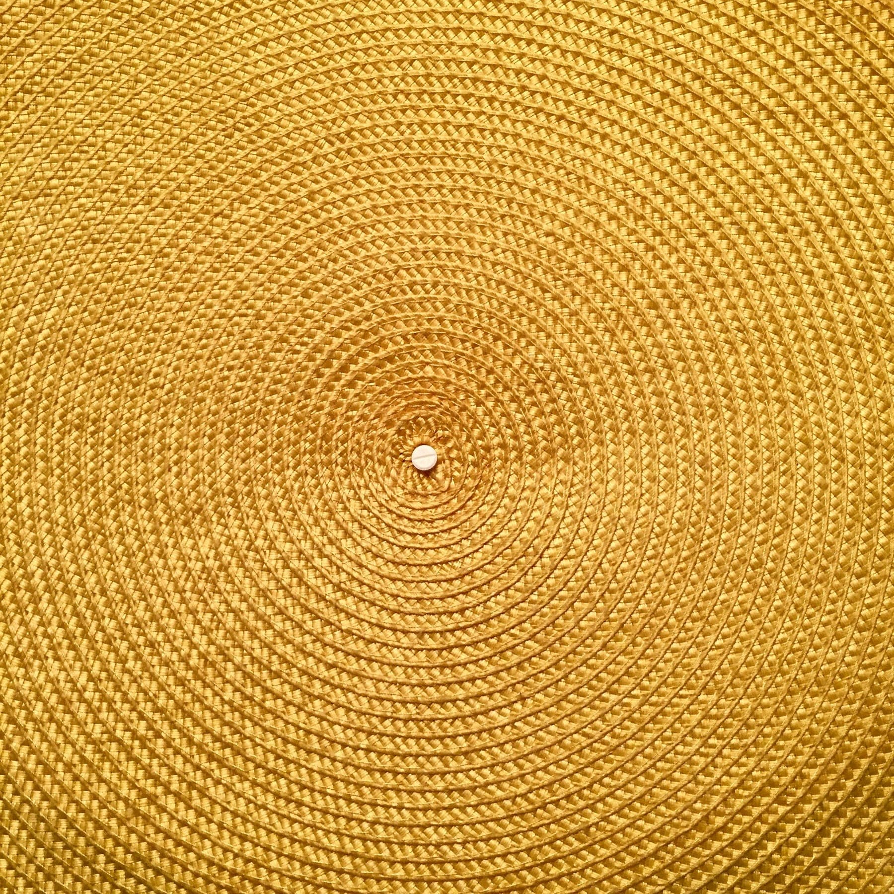 Marigold Braided Round, a hand-loomed cotton rug, shown flat