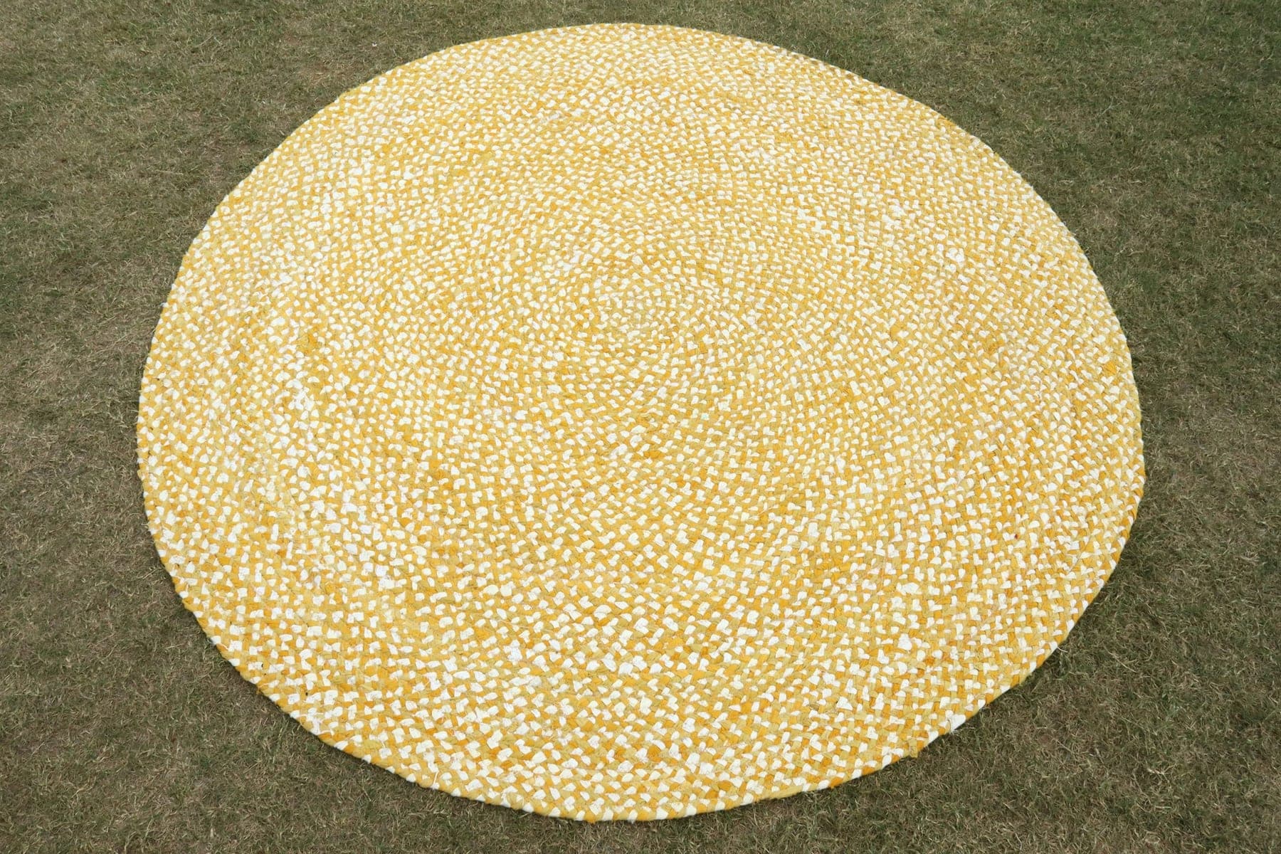 Saffron Braided Round, a hand-loomed cotton rug, shown flat